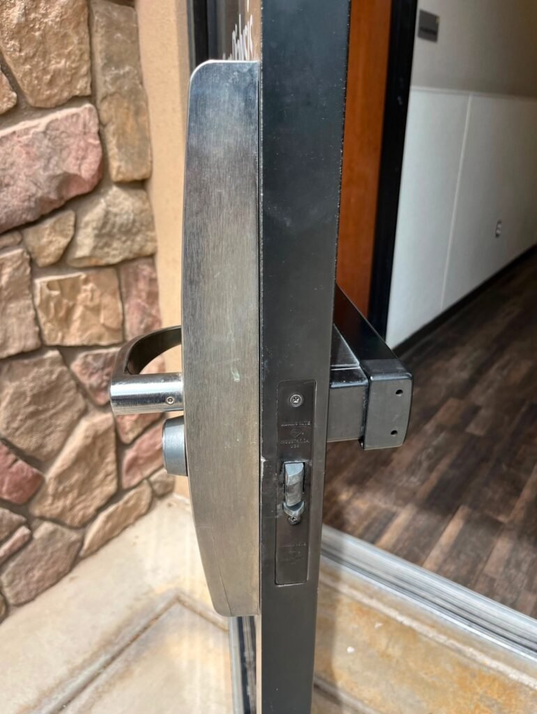 Commercial locksmith technician installing a high-security lock on a business door in Boulder, CO